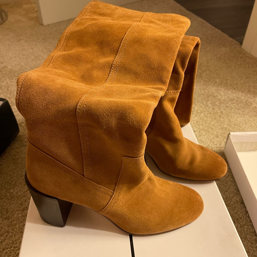 Brown suede knee high boots.